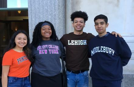 Four students from the Delsay Gives program wearing their college sweatshirts